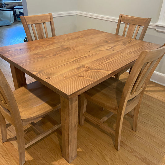 Golden oak parsons table with seamless top and slat back chairs