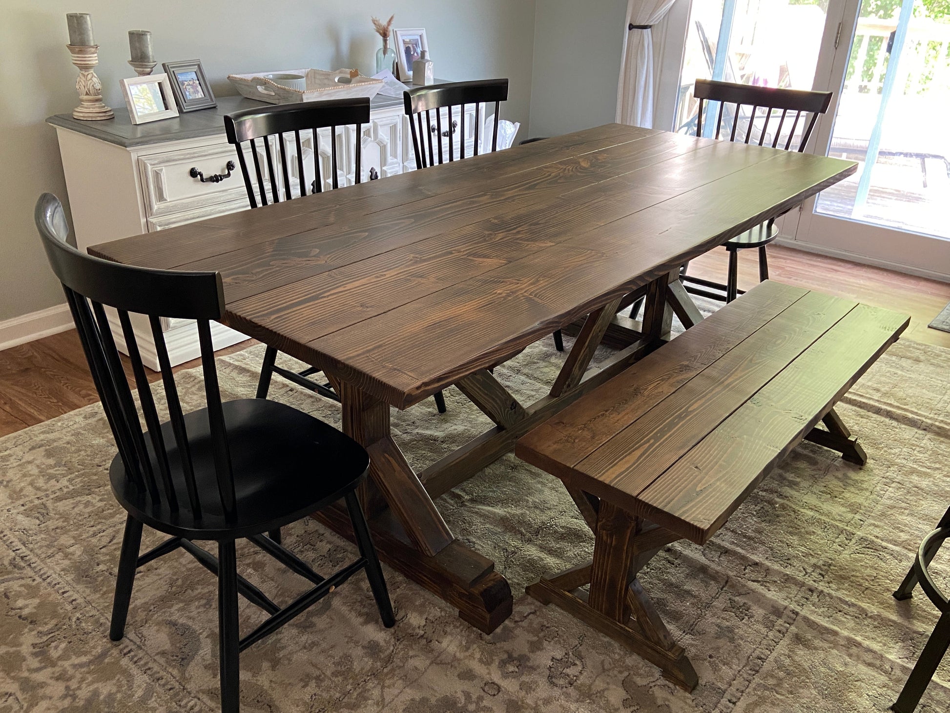 X base trestle table and matching bench in jacobean with a planked table top