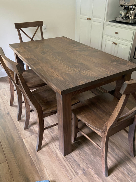 Parsons table with seamless top and 4 single X chairs and an X base bench