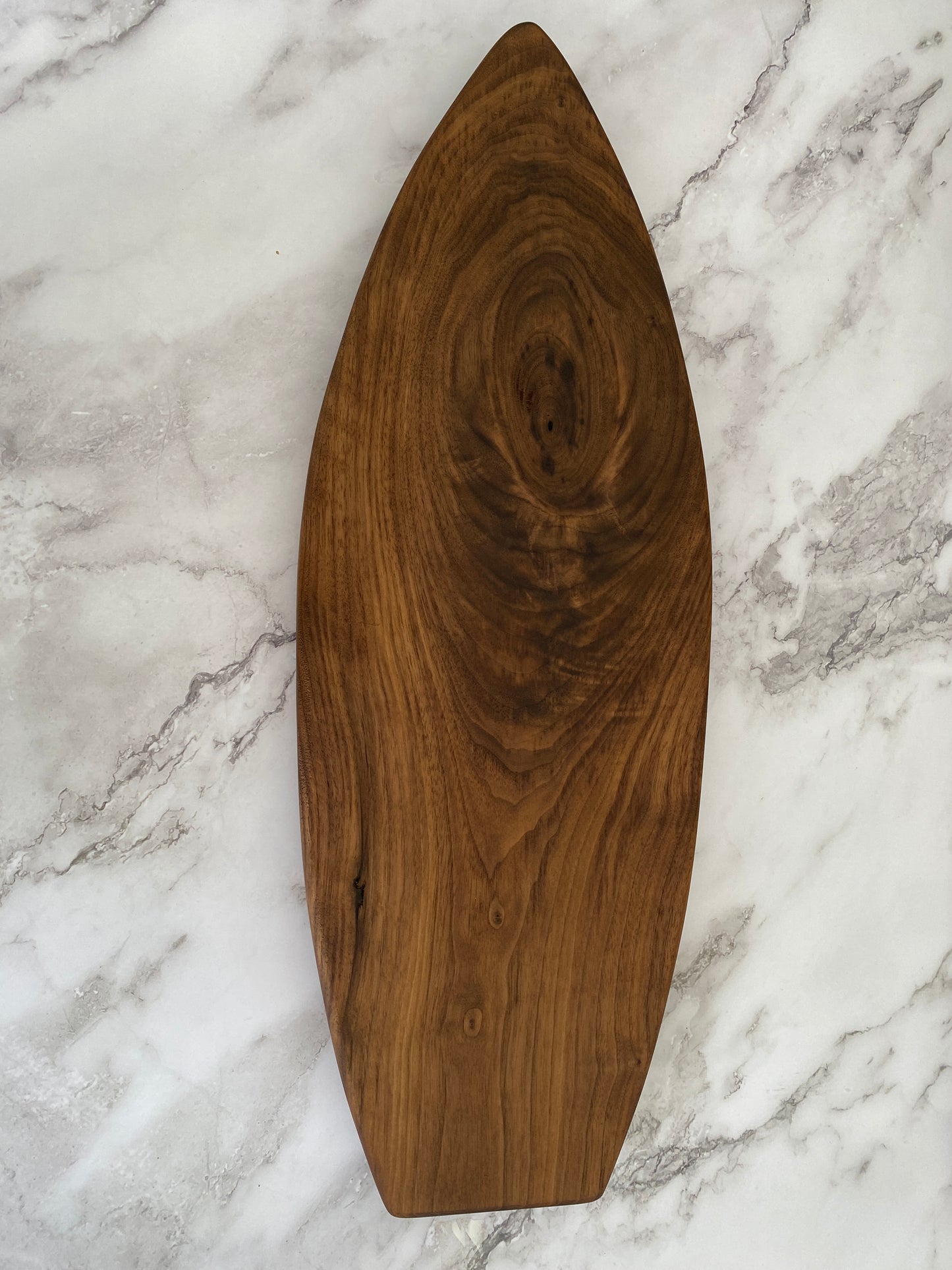 Surfboard shaped charcuterie board